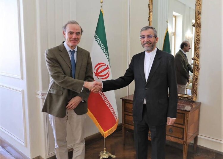 In this photo released by the Iranian Foreign Ministry, Enrique Mora, a leading European Union diplomat, left, shakes hands with Iran's top nuclear negotiator Ali Bagheri Kani in Tehran, Iran, Sunday, March 27, 2022. Mora held talks in Tehran amid hopes that an agreement to restore Iran's tattered nuclear deal with world powers could be completed.