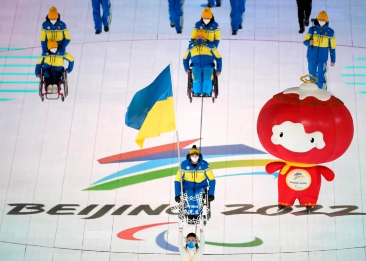 Maksym Yarovyi of Ukraine carries the flag as the team makes their entrance during the opening ceremony at the 2022 Winter Paralympics, Friday, March 4, 2022, in Beijing.