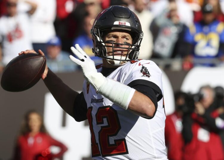 FILE - Tampa Bay Buccaneers quarterback Tom Brady (12) throws a pass against the Los Angeles Rams during the first half of an NFL divisional round playoff football game Jan. 23, 2022, in Tampa, Fla. Brady’s retirement lasted 40 days. He said Sunday, March 13, 2022, he is returning to the Buccaneers for his 23rd season in the NFL.
