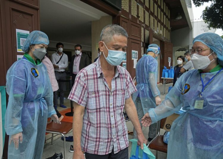 A man leaves after receiving a dose of the Pfizer-BioNTech COVID-19 coronavirus vaccine at a community vaccination center at the Kowloon Mosque And Islamic Centre in Hong Kong, Saturday, March 19, 2022.