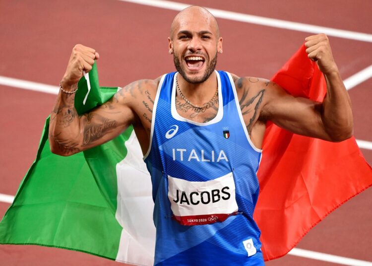 Italy's Lamont Marcell Jacobs celebrates his victory in the men's 60 metres.