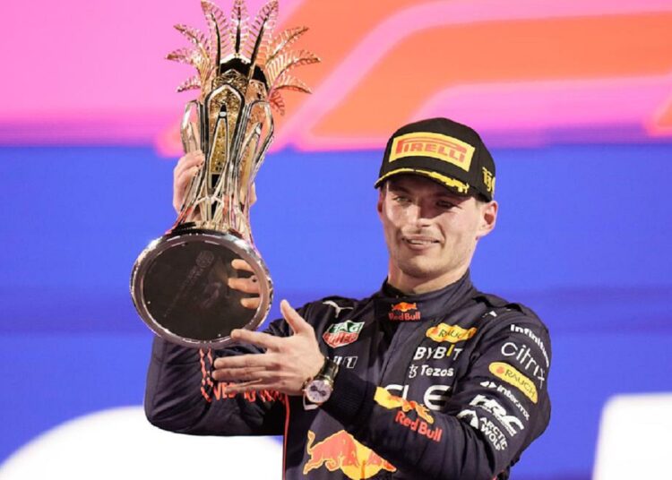 Red Bull's Max Verstappen celebrates on the podium with the trophy after winning the Saudi Arabia Grand Prix in Jeddah.