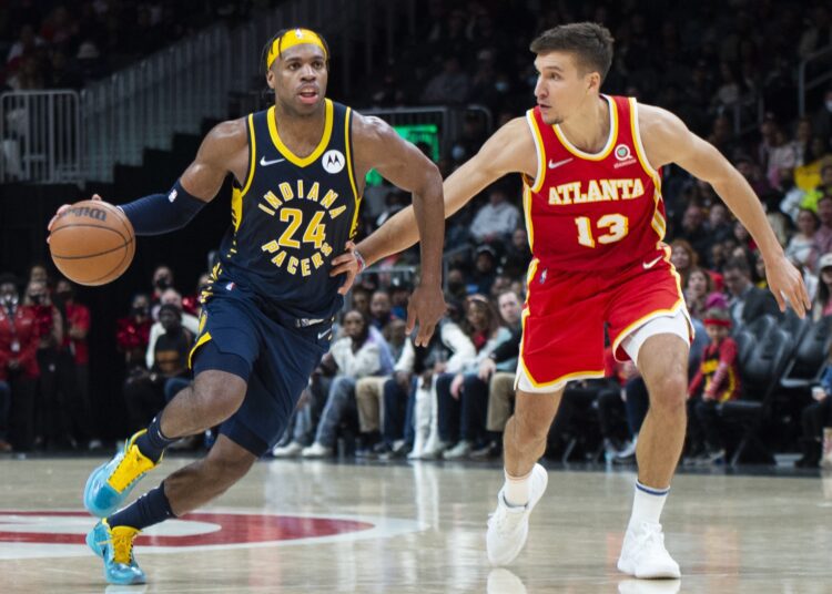 Indiana Pacers Buddy Hield (L) dribbles past Atlanta Hawks Bogdan Bogdanovic during their NBA game in Atlanta.