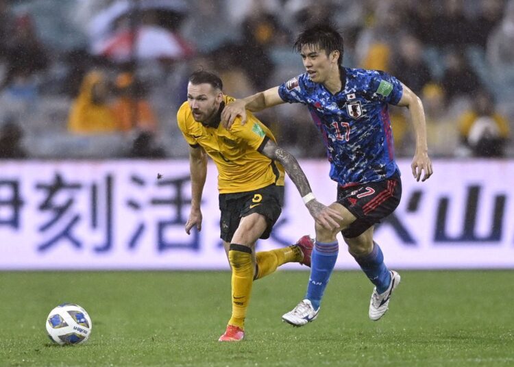 Australia’s Martin Boyle (L) in action with Japan’s Ao Tanaka.
