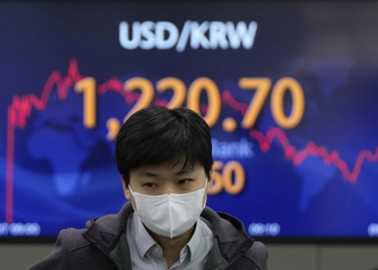 US markets set for lower open; oil prices continue to surge 1 - Egyptian Gazette A currency trader walks near the screen showing the foreign exchange rate between U.S. dollar and South Korean won at a foreign exchange dealing room in Seoul, South Korea, Monday, March 7, 2022. The price of oil jumped more than $10 a barrel and shares were sharply lower Monday as the conflict in Ukraine deepened amid mounting calls for harsher sanctions against Russia.