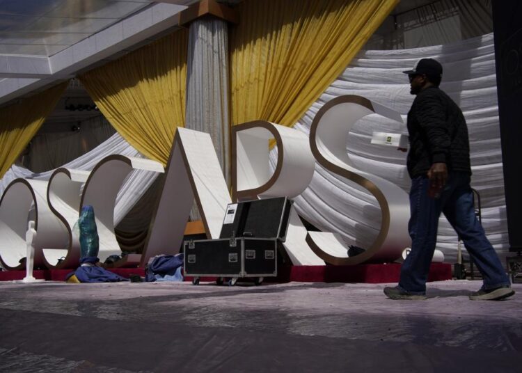 A person walks along the red carpet during preparations for Sunday's 94th Academy Awards outside the Dolby Theatre on Friday, March 25, 2022, in Los Angeles.