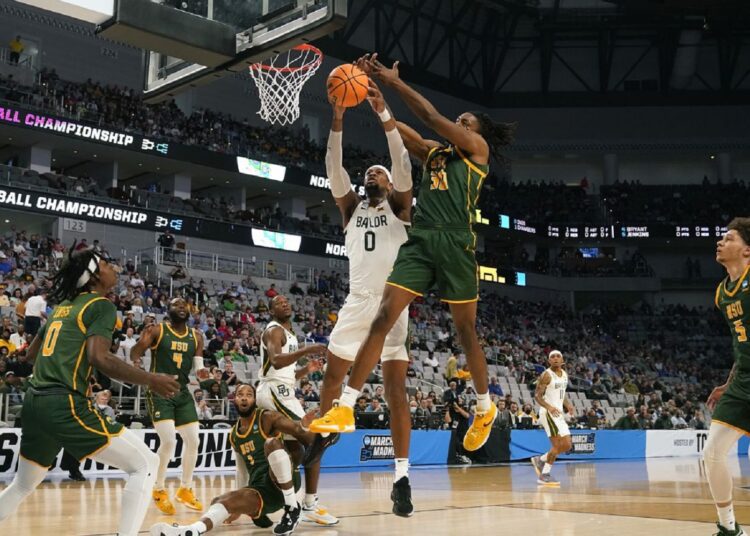 Baylor Flo Thamba (L) and Norfolk State Kris Bankston (R) go up for the rebound during their college basketball game in Fort Worth, Texas.