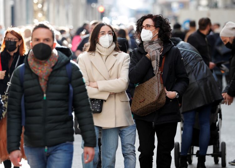 People wear protective masks as they walk down Via del Corso, Rome's main shopping street, as the city makes masks mandatory outdoors in busy areas amid a rise in coronavirus cases, ahead of Christmas, in Rome, Italy, December 4, 2021.