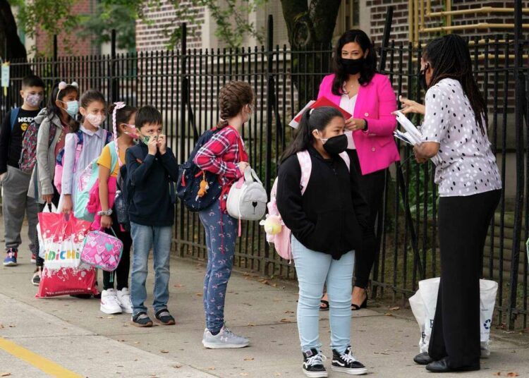 Teachers line up their students before entering elementary school in the Kensington neighborhood, in the Brooklyn borough of New York.
