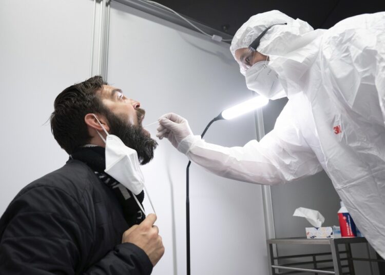 Danilo Schulz sits during a Corona quick test at the Johanniter Corona Test Center in the Palace of Culture in Dresden, Germany, on March 16, 2022.