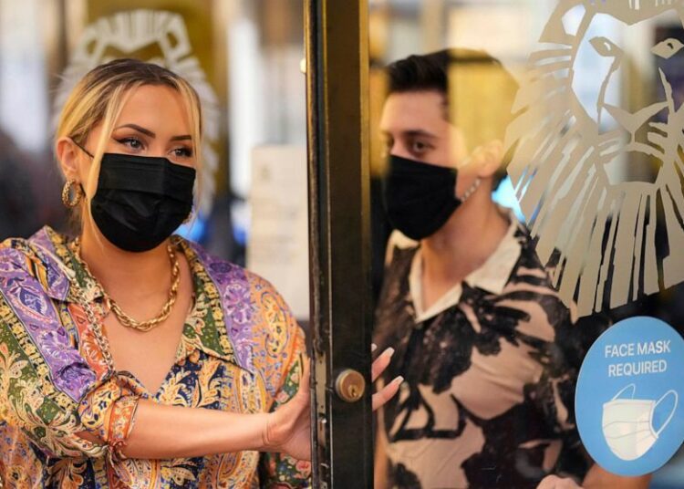Theatergoers wear masks to attend a performance of "The Lion King," on Broadway, at the Minskoff Theatre, Sept. 14, 2021, in New York.