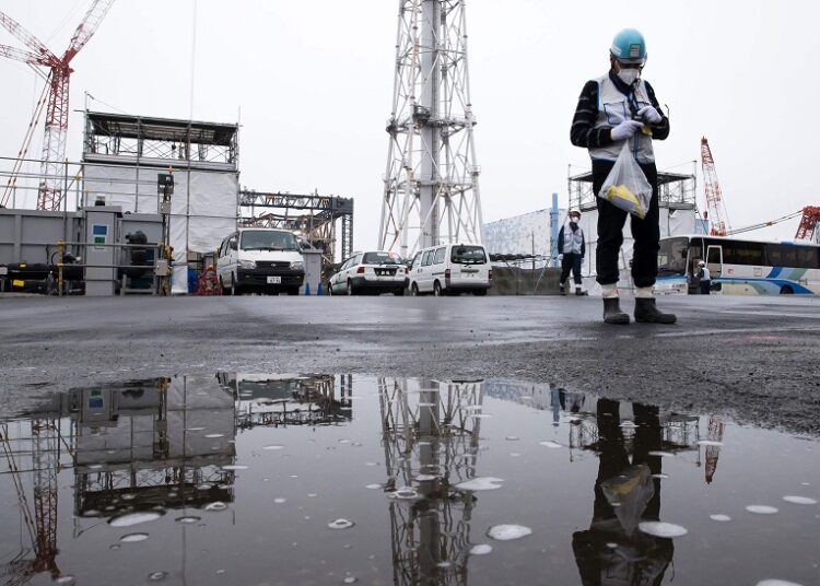 A member of the media uses a geiger counter at Tokyo Electric Power Co’s (TEPCO) Fukushima Dai-ichi nuclear power plant in Okuma, Fukushima on February 23, 2017.