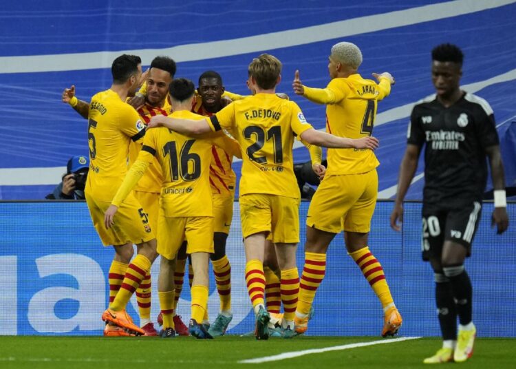 Barcelona's players celebrate after scoring against Real Madrid during a Spanish La Liga match in Madrid.