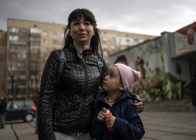 Julia, 34 , cries next to her daughter Veronika, 6, while talking to the press in Brovary, on the outskirts of Kyiv, Ukraine, on Tuesday, March 29, 2022.
