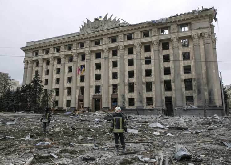 Russia pummels Ukraine’s No. 2 city as convoy nears Kyiv 1 - Egyptian Gazette A member of the Ukrainian Emergency Service looks at the City Hall building in the central square following shelling in Kharkiv, Ukraine, on Tuesday, March 1, 2022.