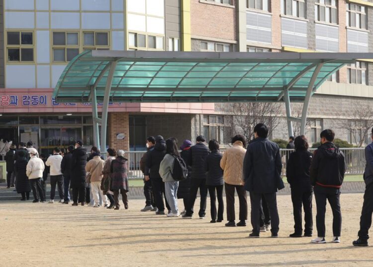 People wait in line to cast their votes for presidential election at a local polling station in Anyang, South Korea, on Wednesday, March 9, 2022.