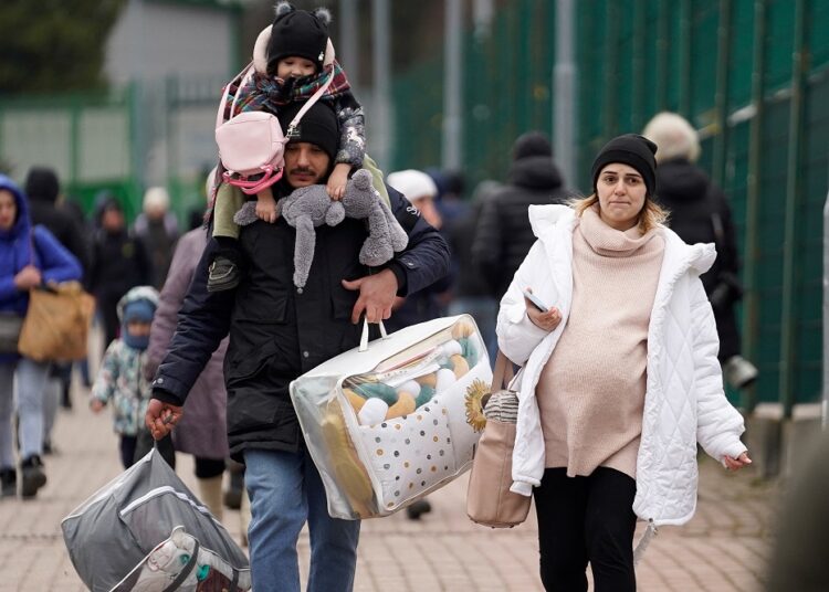 Spain has registered 4,500 Ukrainian refugees so far, minister says 1 - Egyptian Gazette A family exits the border after crossing over to flee violence in Ukraine, in Medyka, Poland February 25, 2022. REUTERS/Bryan Woolston