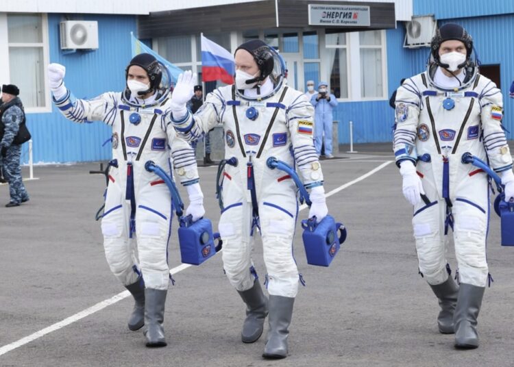 In this photo released by Roscosmos Space Agency, Russian cosmonauts, commander leg rtemyiv, centre, flight engineers Denis atveev, right, and Sergei Korsakov, members of the main crew to the International Space Station (ISS), walk prior to the launch at the Baikonur Cosmodrome, Kazakhstan, on March 18, 2022.