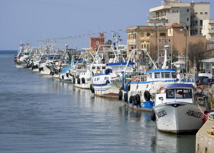 Fishing boats are lined up at harbor in the Roman port of Fiumicino, Friday, March 11, 2022. Fishermen, facing huge spikes in oil prices, stayed in port, mending nets instead of casting them. Nowhere more than in Italy, the European Union’s third-largest economy, is dependence on Russian energy taking a higher toll on industry.