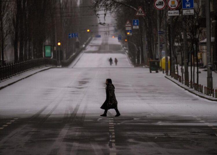 People walking along an empty road during curfew, in Kyiv, Ukraine on March 1, 2022.