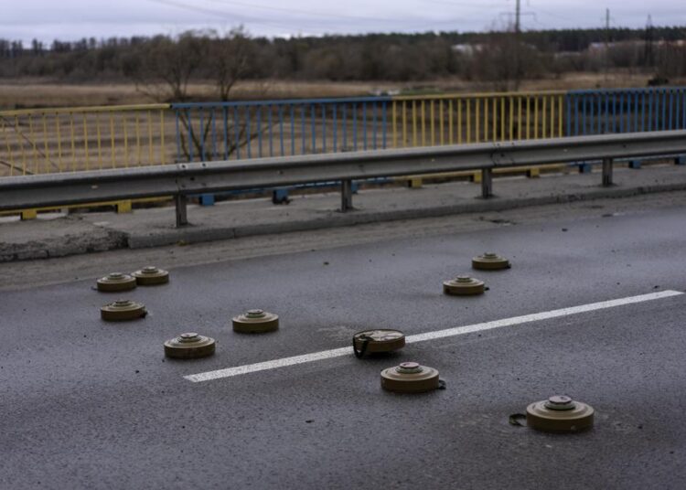 Anti tank mines are displayed on a bridge in Bucha, in the outskirts of Kyiv, Ukraine, Saturday, April 2, 2022.