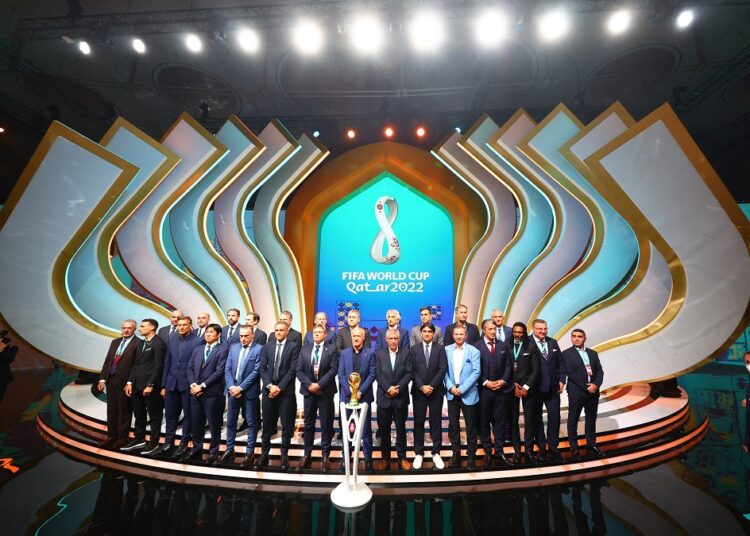 Coaches of the 2022 World Cup teams pose for a photo during the draw in Doha, Qatar.