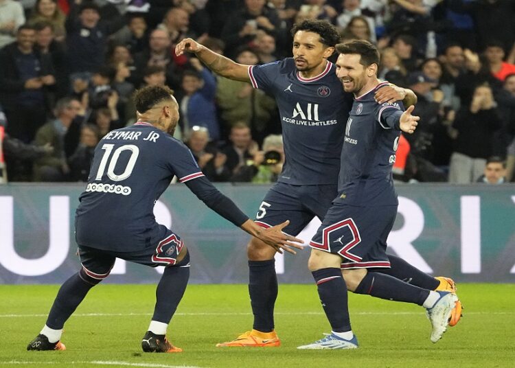 PSG's Neymar (L) and Marquinhos (C) celebrate as Lionel Messi (R) scored the opening goal during the French League One match against Lens at Parc des Princes stadium in Paris.