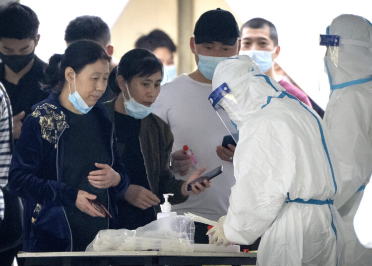 People register for COVID-19 tests at a coronavirus testing facility in Beijing, Saturday, April 23, 2022. Beijing is on alert after 10 middle school students tested positive for COVID-19 on Friday, in what city officials said was an initial round of testing.