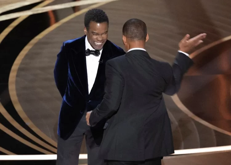 Oscars producer says police offered to arrest Will Smith 1 - Egyptian Gazette Will Smith (R) hits Chris Rock during the Oscars ceremony.