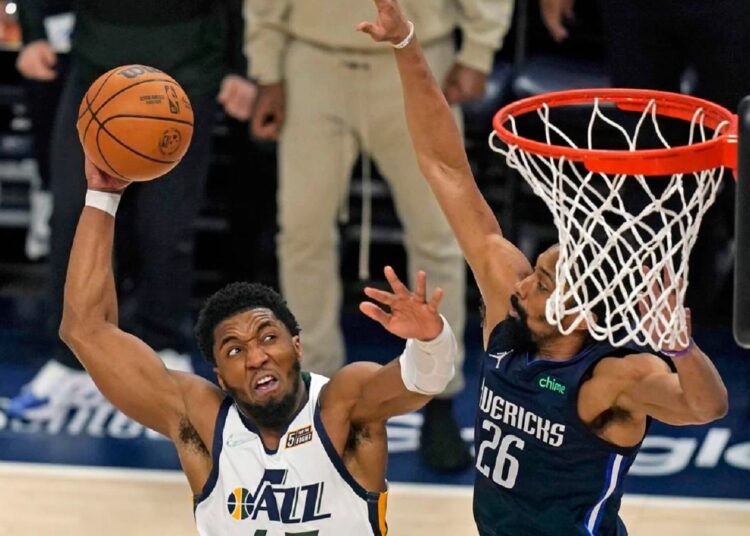 Utah Jazz Donovan Mitchell (L) goes to the basket as Dallas Mavericks Spencer Dinwiddie defends during their NBA game in Salt Lake City.