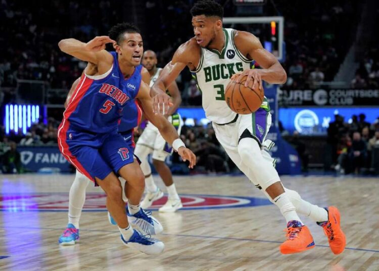 Milwaukee Bucks Giannis Antetokounmpo (R) drives on Detroit Pistons Frank Jackson during their NBA game in Detroit.