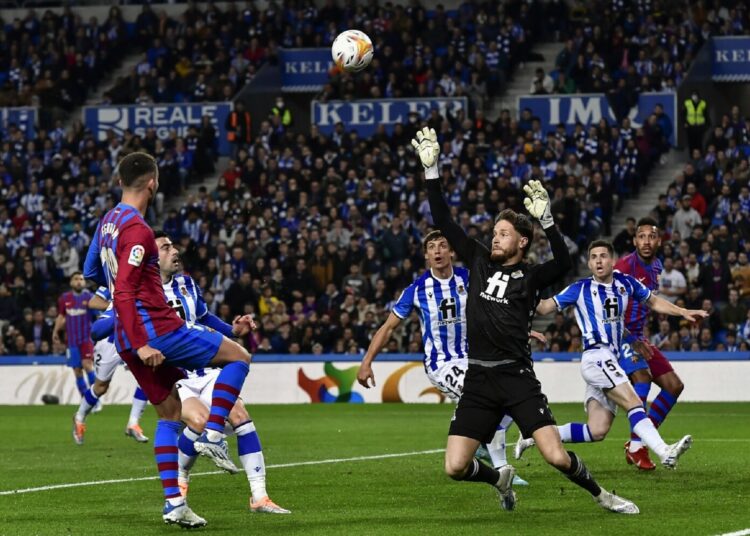 Barcelona's Ferran Torres (L) tries a shot during a Spanish La Liga match against Real Sociedad in San Sebastian, Spain.