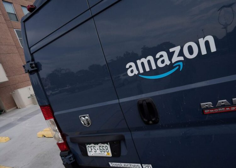 A file photo showing the company logo graces one of the doors of a delivery van for Amazon in Denver. Amazon said that it will add a 5% "fuel and inflation surcharge" to fees it charges third-party sellers who use the retailer's fulfillment services as the company faces rising costs.