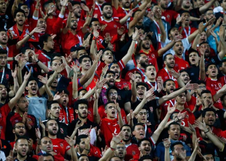 Al-Ahly supporters cheer for their team during the CAF Champions League quarter-final first-leg match against Raja at the Al-Salam Stadium in Cairo.