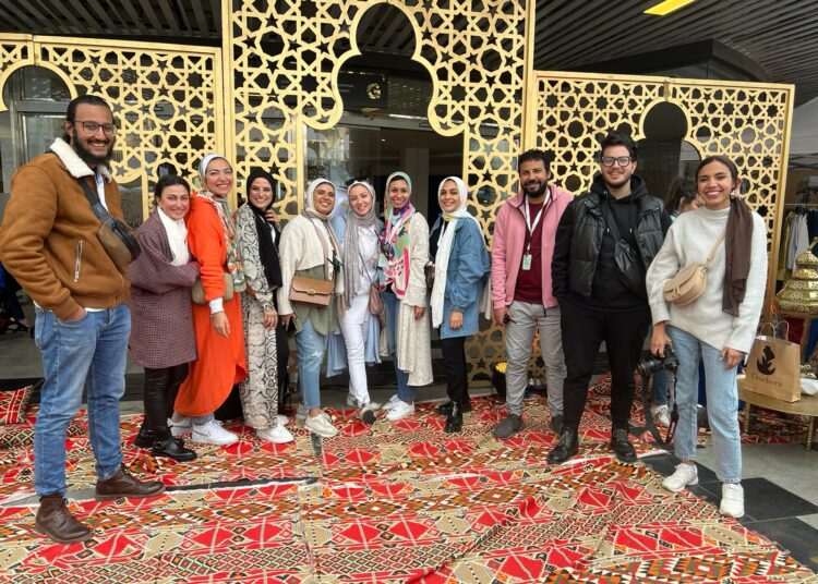 Lydia Akram (Centre), founder of L.A market is posing to a photo during one of the recent events for Egyptian designers and small businesses, together with her team.