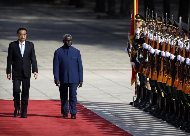 A file photo showing Chinese Premier Li Keqiang, (L), and Solomon Islands Prime Minister Manasseh Sogavare review an honour guard during a welcome ceremony at the Great Hall of the People in Beijing, in October 9, 2019.