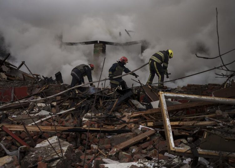 Firefighters work to extinguish a fire after a Russian attack destroyed the building of a Culinary School in Kharkiv, Ukraine, on Tuesday, April 12, 2022.