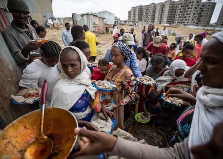 Displaced Tigrayans queue to receive food donated by local residents at a reception center for the internally displaced in Mekele, in the Tigray region of northern Ethiopia on May 9, 2021.