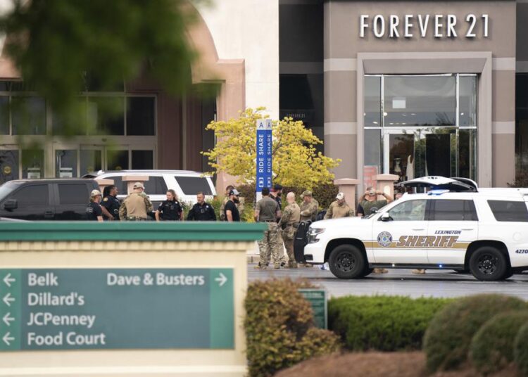 FILE - Members of law enforcement gather outside Columbiana Centre mall in Columbia, S.C., following a shooting, April 16, 2022. Authorities in South Carolina say they are investigating shooting at a club in Hampton County early Sunday, April 17, 2022 that left at least nine people injured. It was the second mass shooting in the state in as many days.