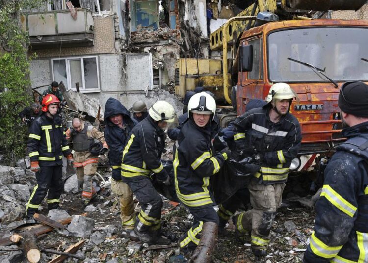 Ukrainian troops surrendering at Mariupol registered as POWs 1 - Egyptian Gazette Rescuers carry the body of a civilian at a site of an apartment building destroyed by Russian shelling in Bakhmut, Donetsk region, Ukraine, yesterday.