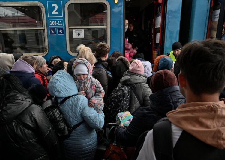 Ukrainian refugees get on the train to Warsaw, at the Przemysl railway station, near the Polish-Ukrainian border, on March 7, 2022.
