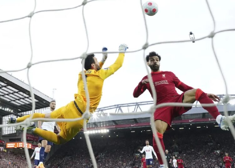 Tottenham's goalkeeper Hugo Lloris (L) makes a save in front Liverpool's Mohamed Salah during their English Premier League match in Liverpool.