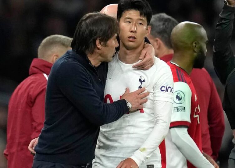 Tottenham's Son Heung-min talks with Antonio Conte after he was substituted during the English Premier League match against Arsenal in London.