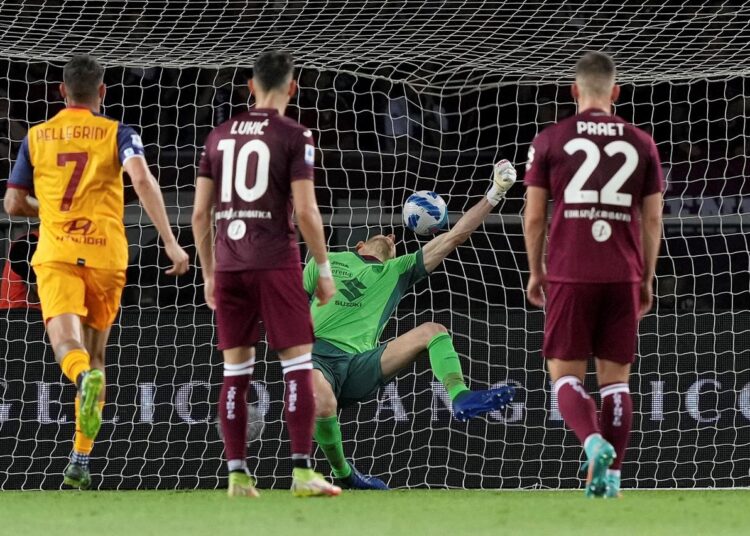 Roma's Tammy Abraham, not seen, scores his side's second goal past Torino's goalkeeper Etrit Berisha during their Italian Serie A match in Turin.