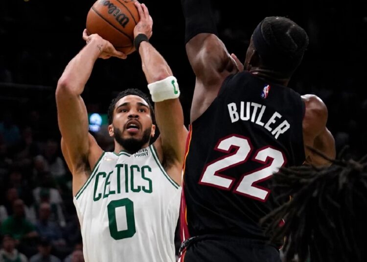Boston Celtics Jayson Tatum (L) shoots over Miami Heat Jimmy Butler (22) during the second half of Game 4 of the NBA playoffs Eastern Conference finals.