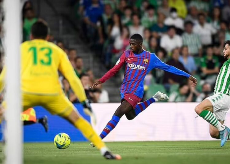 Barcelona's Ousmane Dembele (C) in action during the Spanish La Liga match against Real Betis in Seville.