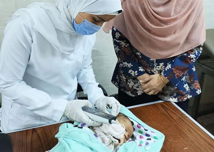 3 million children examined for hearing impairment - Health min. 1 - Egyptian Gazette A medical workers checks on the hearing of a child in a hospital.