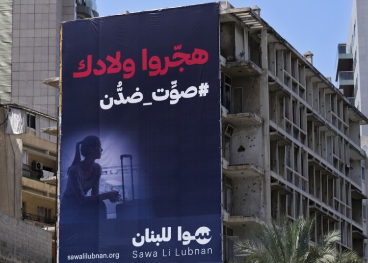 A giant electoral billboard for the upcoming parliamentary elections, hangs on an abandoned building, in Beirut, Lebanon.