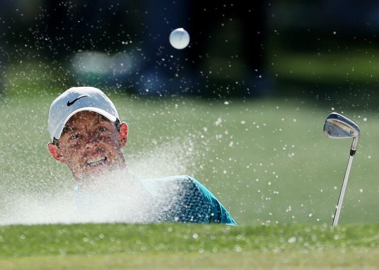 FILE PHOTO: Golf - The Masters - Augusta National Golf Club - Augusta, Georgia, U.S. - April 10, 2022 Northern Ireland's Rory McIlroy plays a shot from a bunker on the 17th during the final round REUTERS/Mike Segar