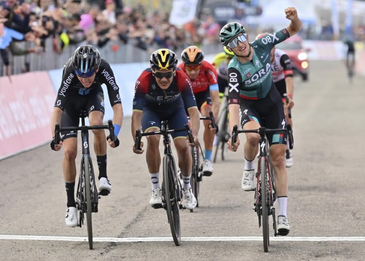 Australia's Jai Hindley (R) crosses the finish line to win the 9th stage of the Giro D'Italia cycling race in Italy.
